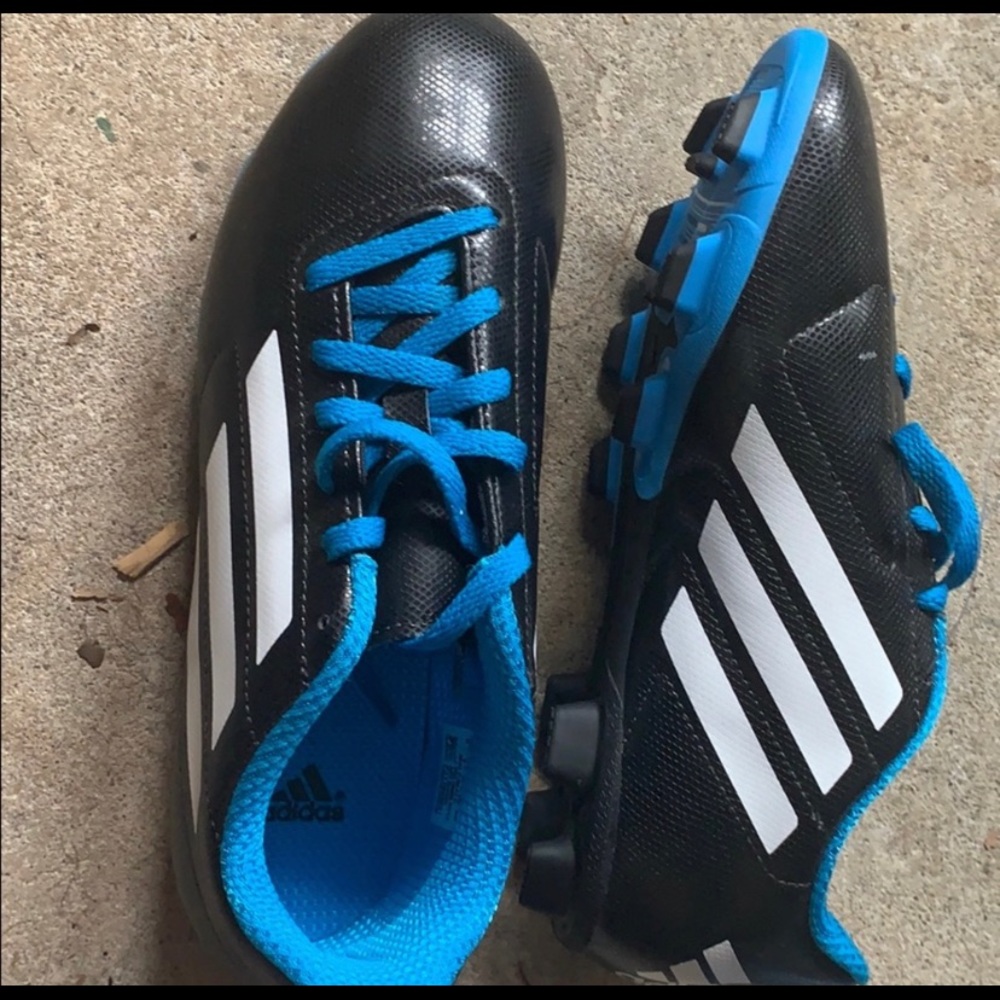 Two pairs of boys soccer cleats